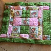 I Never Promised You a Rose Garden (Quilt) - finished quilt on a tile floor
