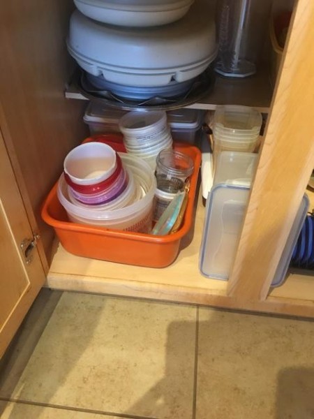 Containers reorganized in a cabinet.
