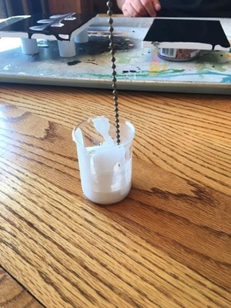Go With the Flow Painting - dipping chain into a cup of white paint