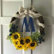 My First Wreath - grapevine wreath with sunflowers and a tan burlap ribbon bow
