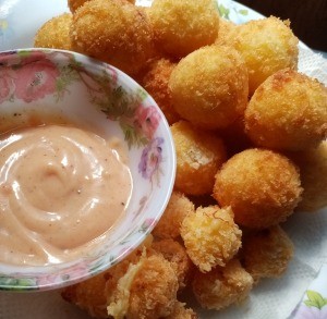 Cheese Filled Potato Ballson plate with sauce