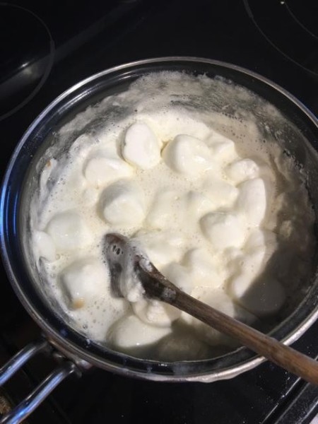 Melting marshmallows in a pan.