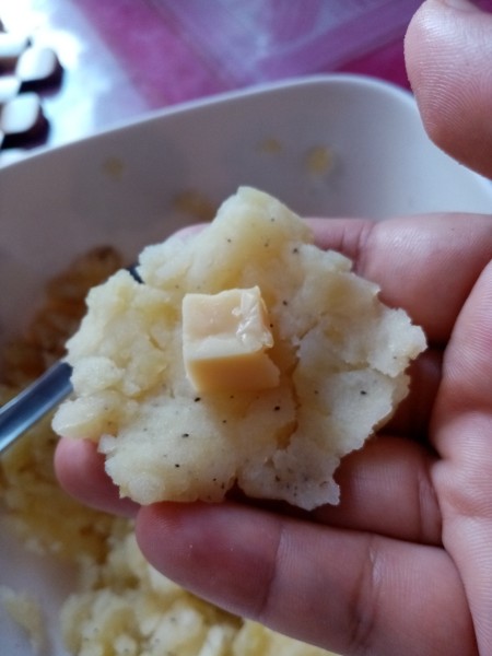 mashed potatoes with cheese square in hand