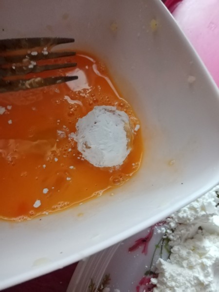 dipping Potato Ball in egg