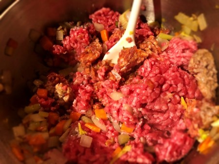 adding sausage & beef to vegetables