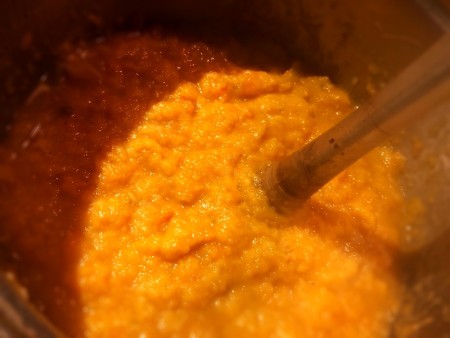 Using an immersion blender, blend the contents of the soup pot.
