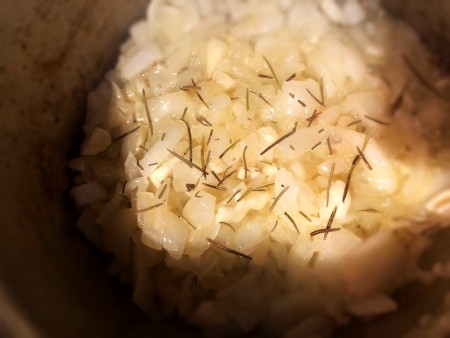 Onions and spices being sauteed in an Instant Pot.