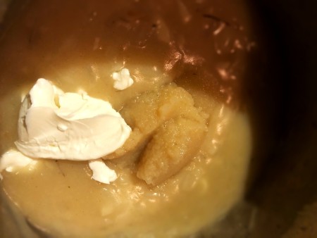 Adding cream cheese and applesauce to the mixture.
