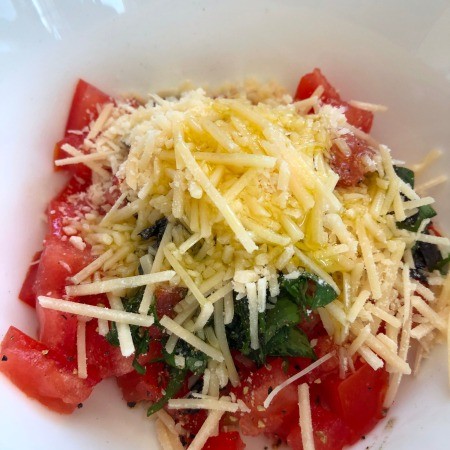 A close up of the tomato, basil and garlic topping.