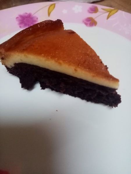 A piece of custard chocolate cake before being glazed.