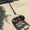 Value of a Craftsman Yard Man Reel Mower - old reel mower on driveway