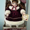 Value of a Collector's Choice Musical Porcelain Doll - doll wearing a white faux fur trimmed coat and hat