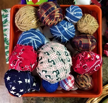 Americana Ball Wreath - plastic tub with balls wrapped in various strips of fabric and two twine balls