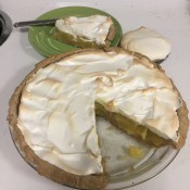 The finished baked pie with a slice out of it.