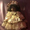 Identifying a Porcelain Doll - black doll with ecru lace dress and hat trimmed with brown ribbon