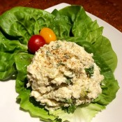 A serving of chicken potato egg salad on a lettuce leaf.