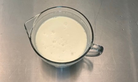Milk and sweetened condensed milk in a mixing bowl.