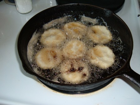 Frying cornbread in a cast iron pan.