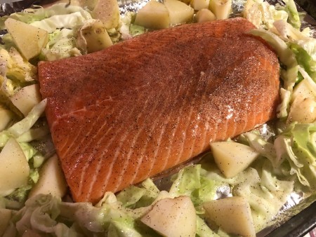 Salmon on a bed of vegetables.