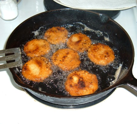 Frying cornbread in a cast iron pan.