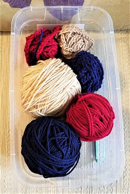 Crocheted Americana Roses - yarn and hook in a plastic box