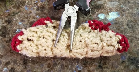 Crocheted Americana Roses- holding the folded rose down with a pair of pliers