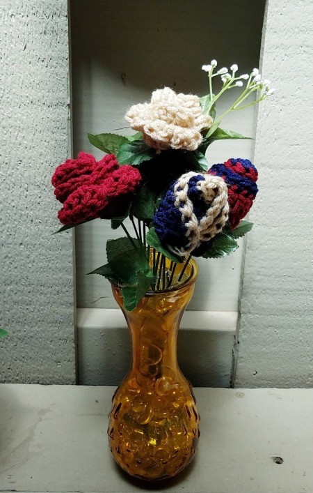 Crocheted Americana Roses - crochet roses, buds, and baby's breath in an amber glass vase