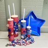 Faux Firecrackers - final display with plastic blue star bowl and red, white, and blue beads arrayed in front of the four firecrackers
