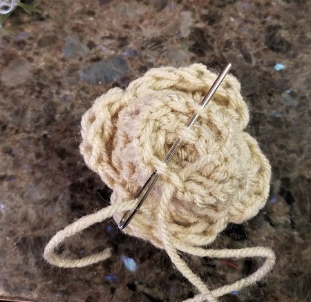 Crocheted Americana Roses - using the darning needle to sew the rose together on the bottom