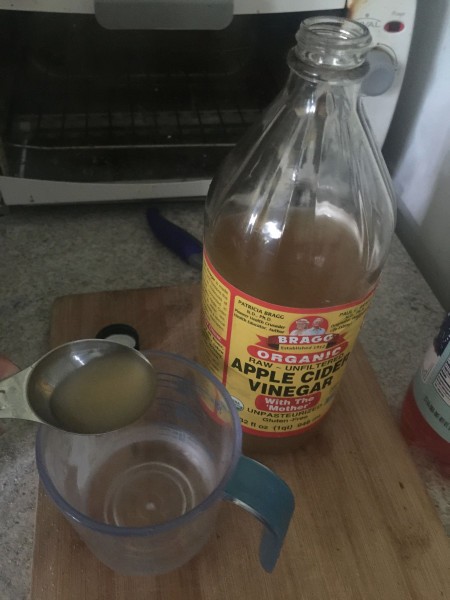 Apple cider vinegar being measured.