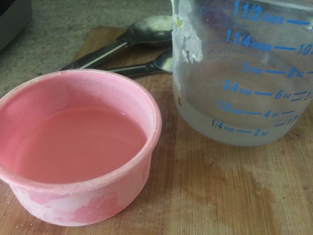 Measuring water in a measuring cup.