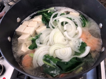 A stockpot of bok choy tofu shrimp soup.