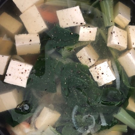 A stockpot of bok choy tofu shrimp soup.