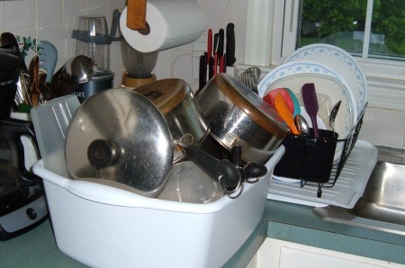 Dishes drying in a dishpan.