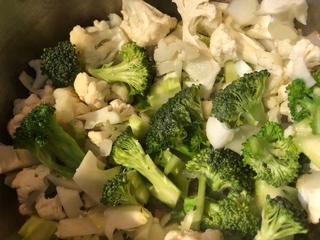 Cauliflower and broccoli in a soup pan.