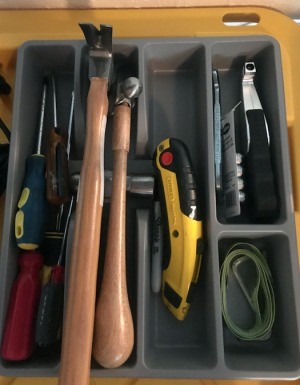 A flatware tray holding tools.