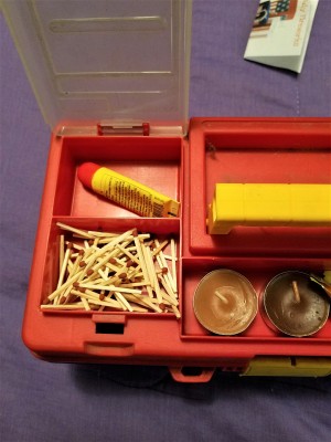 Supplies placed in the bottom of a tool box.