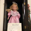 Value of an Ashley Belle Doll? - doll wearing a pink dress in a black wooden case