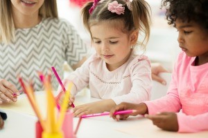 A group of children coloring.