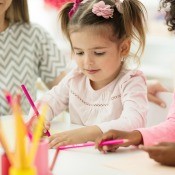 A group of children coloring.