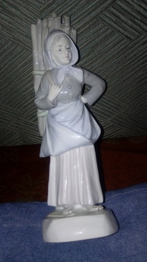 Identifying a Ceramic Figurine - nearly monochromatic figurine of a woman carrying firewood on her back