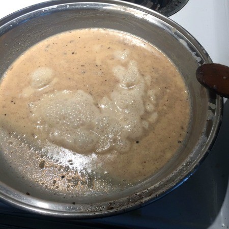 Cooking the ice cream mixture in a pan.