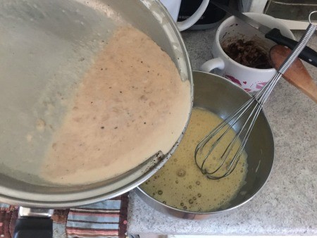 Combining the milk mixture with eggs.