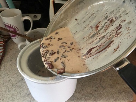 Adding the mixture to the ice cream maker.