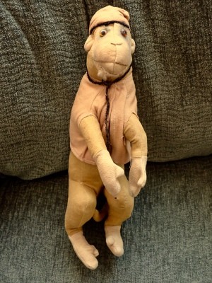 The front of a vintage toy monkey.