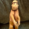 The front of a vintage toy monkey.