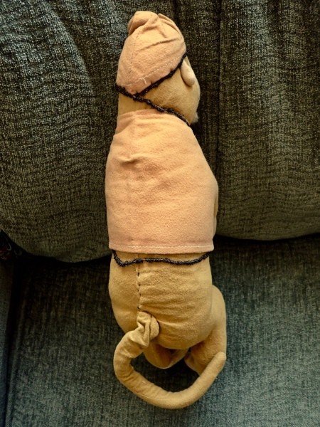 The back of a vintage stuffed monkey.