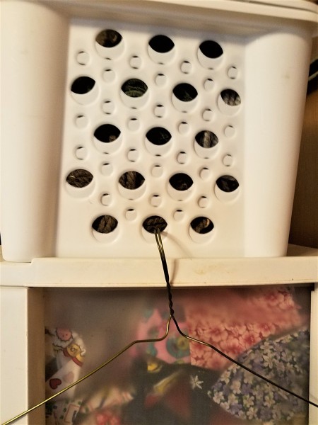 Hanger, Clips, and Rings for Craft Storage - closeup of the hanger hanging from the plastic basket with holes