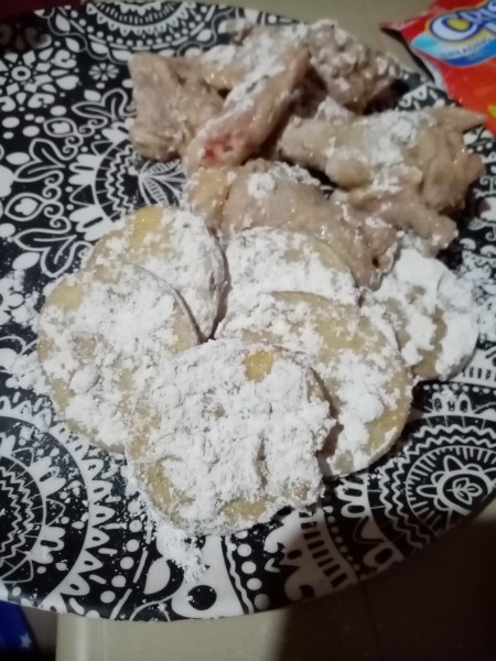 Chicken pieces dredged in flour.