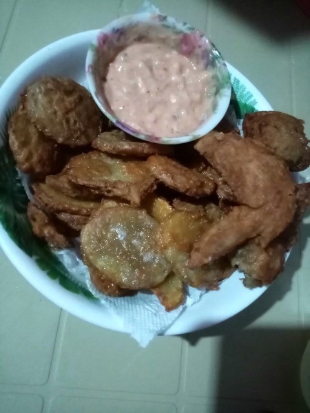 A plate of chicken and mojos with a dipping sauce.